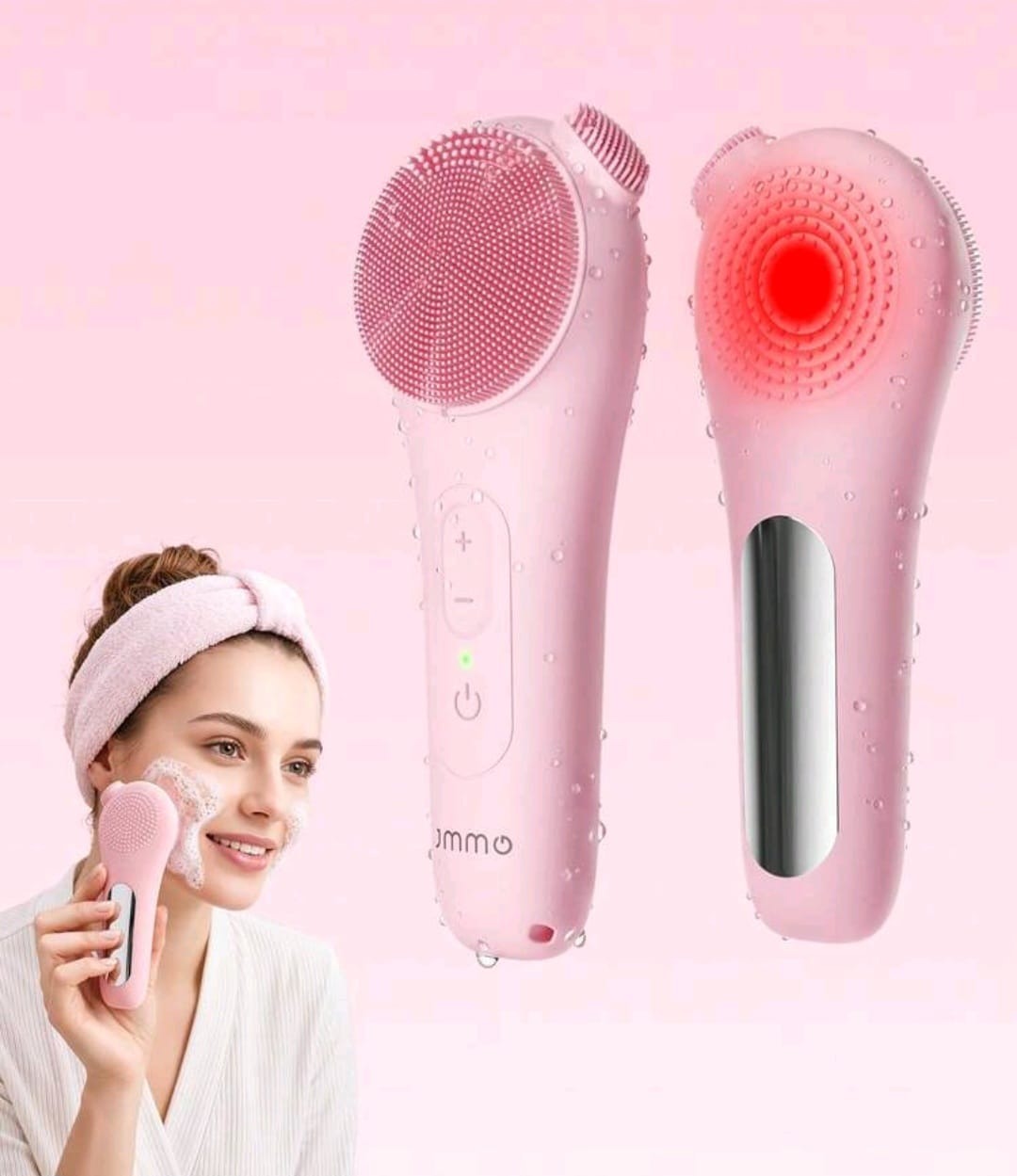 Pink electric facial cleansing brush with red light therapy shown beside a model